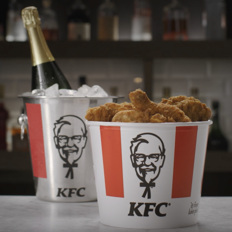 A bucket of KFC and a bottle of bubbly.