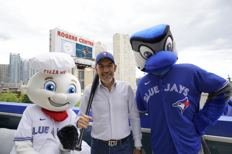 Pizza Nova kicks off another season as the Toronto Blue Jays’ official pizza. In front of the Rogers Centre are, from left to right, Leonardough, the official mascot of Pizza Nova, Domenic Primucci, the President of Pizza Nova, and Ace, the official mascot of the Toronto Blue Jays, taken June 27, 2022.