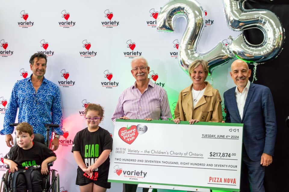 Pizza Nova president Domenic Primucci presents a cheque for $217,874 to Karen Stintz, CEO of Variety – The Children’s Charity of Ontario, at Variety Village, June 4, as a result of the 2024 “That’s Amore Pizza for Kids” fundraiser as they celebrate the 25th anniversary of the campaign. From left to right, Mike Primucci, Ben and Stella, Variety Ambassadors, Sam Primucci, Founder of Pizza Nova, Karen Stintz, Domenic Primucci.