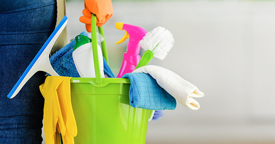 Cleaning Industry graphic: A plastic bucket filled with house cleaning tools, rags, squeeze bottles, toilet brush, and squeegee
