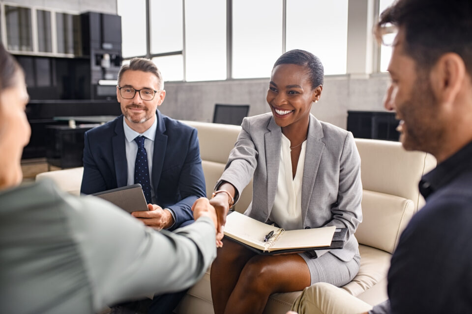 Business employees shaking hands during franchise discovery process